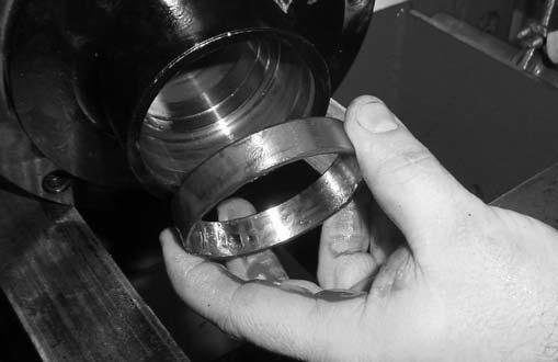 If the bearings do not roll smoothly when rotated, replace them.