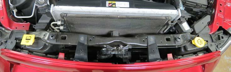 16. Using a 10mm socket, remove four (4) bolts securing the grill.