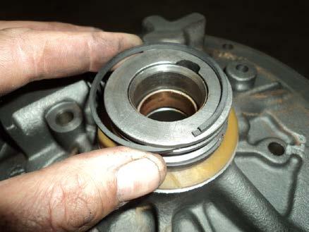 Remove and discard the two oil seal rings (208) from the pump cover (202). 1964 to 1974 models were assembled with iron hook type rings.