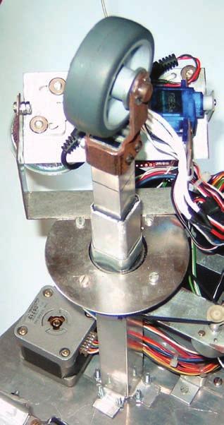 To increase the adhesion of the wheels to the ground (reduce the skid), the vertical supporting wheel is pulled up (using a stepper motor with a worm gear) and presses