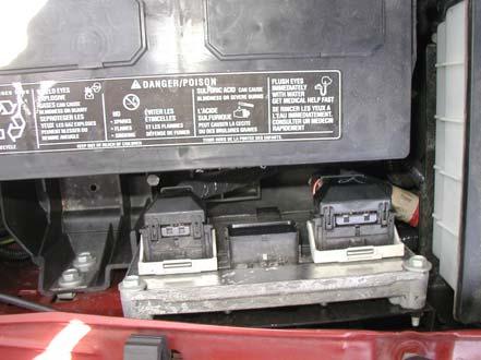 Remove the battery cover by releasing the tab located on the left side (towards the front of the vehicle) of the battery cover. You may need to use a screwdriver to pry the tab. 3.