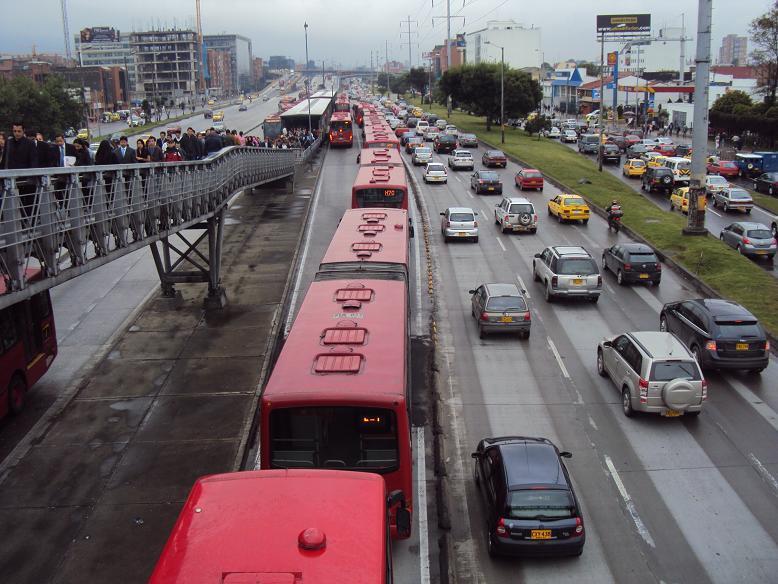 much as several minutes. The photograph in Figure 2 below shows a long queue at a Transmilenio station with many buses bypassing the next station.