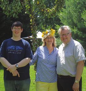 Page 4 Photo by Sue Morse Sue and Peter Kopperman, along with their son David, who graduated from high school this year, pose in front of their Midsummer pole, which decorated the back yard at their
