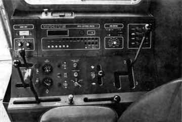 Instruments: The right instrument console (FIGURE 3B) contained gauges, warning lights, a digital readout and a grain loss monitor.