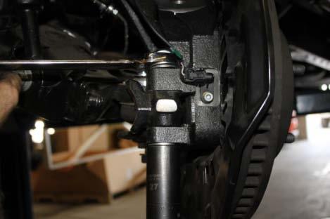 Break upper ball joint loose by hitting the side of the