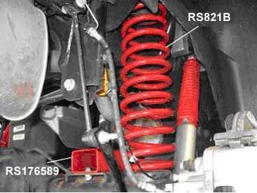 4) On driver side place coil spring RS821B onto the rear axle pigtail end down. Attach original insulator to top of coil, then raise the axle guiding the springs into the frame pockets.