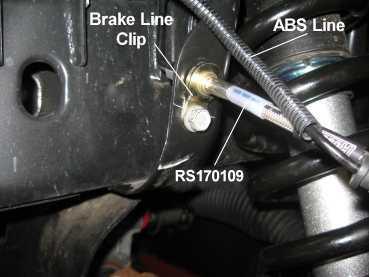 Attach the front caliper to the steering knuckle with the original mounting bolts. Tighten the caliper mounting bolts to 130 ft. lbs. 4) Remove the brake hose banjo bolt at the caliper.