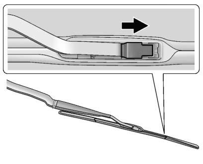 244 Vehicle Care 3. Lift up on the latch in the middle of the wiper blade where the wiper arm attaches. 4.
