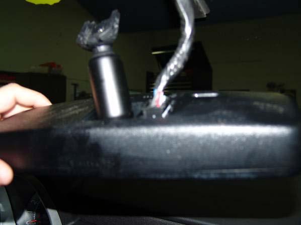 Loosen the screw that attaches the existing rear view