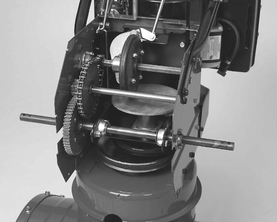 As the friction wheel begins to turn, it drives gears, or sprockets and chains, which provide the speed reduction for the axle.