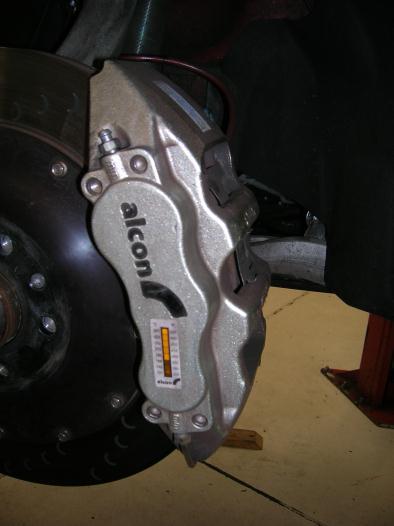 8 Place the caliper with the brake pads installed onto the caliper mounting bracket and install the caliper mounting bolts M12 x 1.75 x 60, making sure to put anti-seize on the threads.