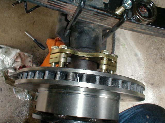 4. Bolt the Axle Tube bracket to the outside of the housing using the (4) 1/2-20 T- bolts, and Lock
