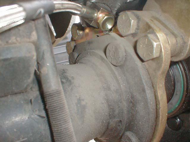Drivers Side (Caliper between axle tube and rear bumper).