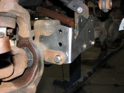Refer to figures 5-1 and 5-2 for illustration of this step when completed. Of the two remaining brackets, one has half moon cutouts to fit over the axle tube.