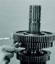 Apply slight downward pressure to spread the gears evenly. Between the gear hub and mainshaft spacer, insert 0.