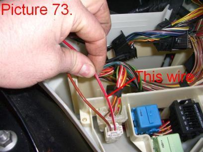 Locate the indicated red/white wire inside the