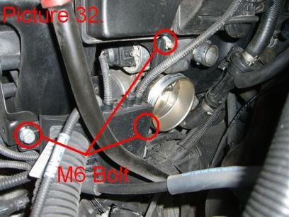 Remove the three 10mm bolts (two bolts and 1 nut) holding the engine wiring harness brackets (Pic.