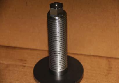 The adjustment screw should be removed from the spring block for examination of its threads. A visual exam is all that is needed for the adjustment screw.