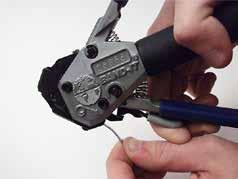 To loosen or remove band after blue pull-up handle locks against tool body, squeeze pull-up handle and push tension release lever on top of tool forward.