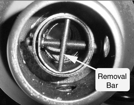 Clean the screen with an exhaust cleaning solution and replace, securing it by tightening the retaining nut.