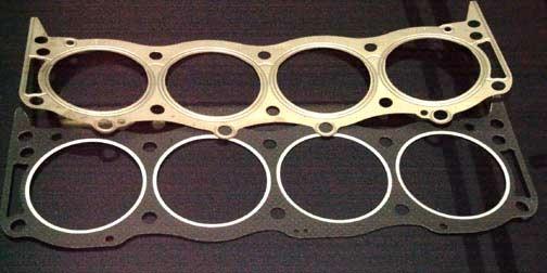 The photo below shows the differences between new and old type gaskets. Once the heads are on we install the exhaust manifolds.