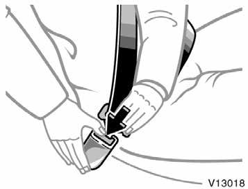 To release the belt, press the buckle release button and allow the belt to retract.
