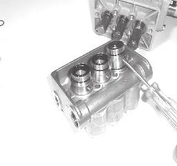 The valve assemblies can be separated by inserting a small screw driver between the valve seat (#27) and its