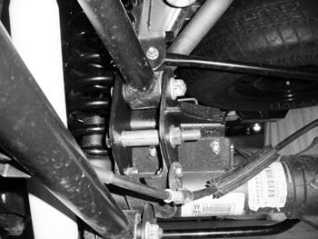 Place the upper control arm relocation bracket over the pocket. The plate will be offset towards the inside of the vehicle.