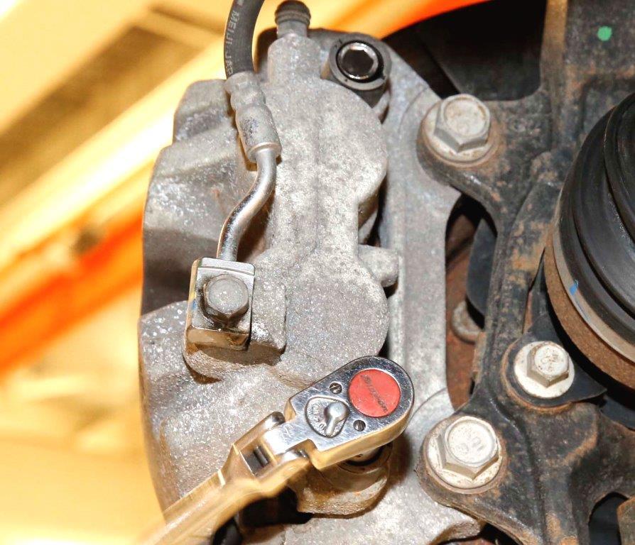 Loosen, but do not remove, the brake flex hose banjo bolt (Figure 4). SLIDE BOLT LOCATIONS ADAPTER 6.