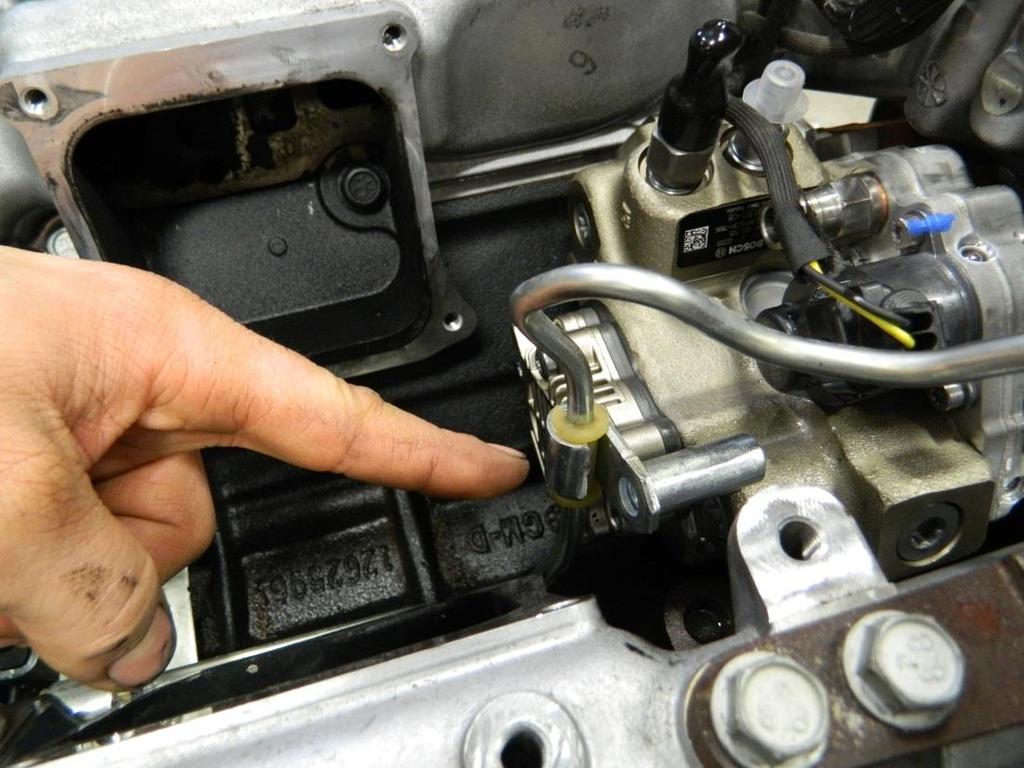TIP: Carefully remove the high pressure fuel line mount in the location shown below.