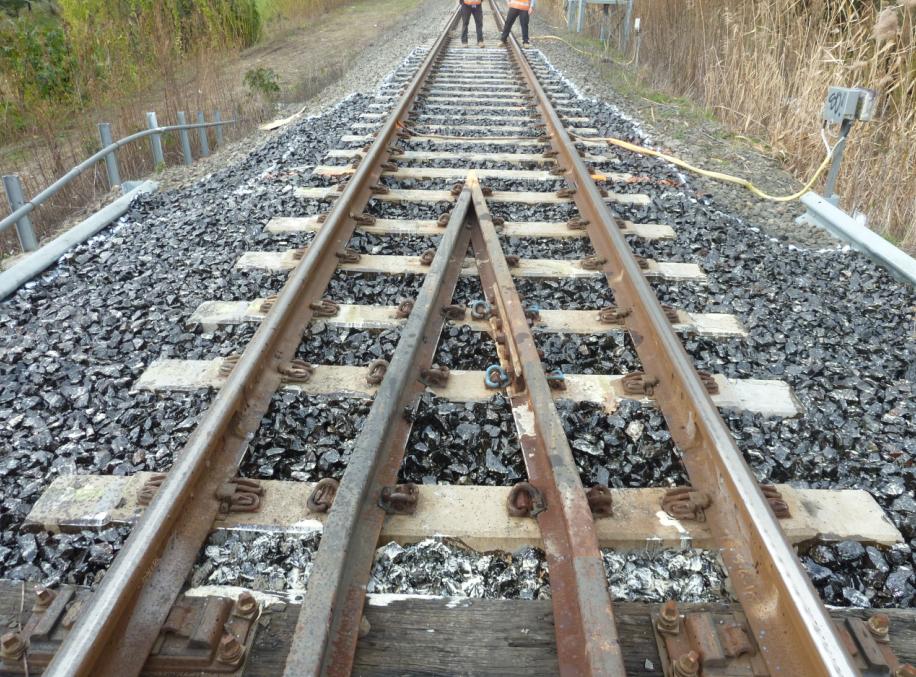 2.2 Implementation of Ballast Glue/Bond Both bridge ends were tamped by a tamping machine in order to adjust and correct track surface before applying ballast glue/bond.