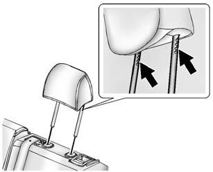 To reinstall the head restraint: 1. Insert the head restraint posts into the holes in the top of the seatback. The notches on the posts must face the driver side of the vehicle. 2.