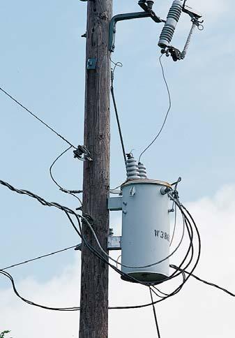 Figure 14-19 Step-down transformers like this one are used to reduce the voltage across power lines so that the electrical energy supplied to homes and businesses is safer to use.