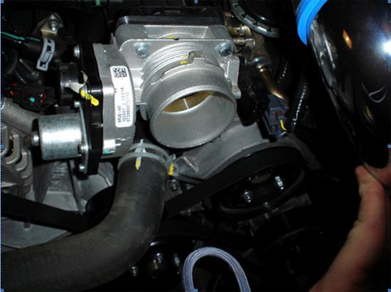 Once power has been disconnected from the throttle body, you will need to disconnect your Mustang s air intake from the front intake of the throttle body unit.