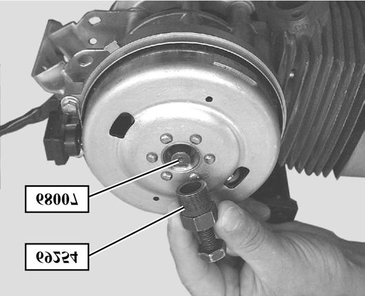 with the adjustable pin wrench P/N 755586 - Tighten the flywheel extractor thrust bolt until the rotor is freed To remove the coil assembly and the