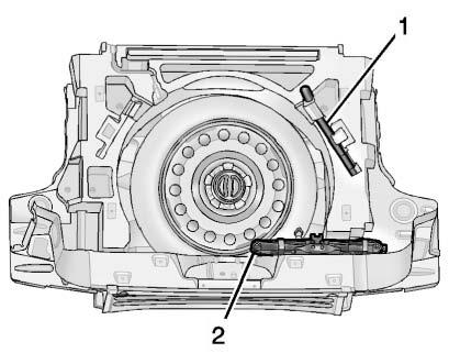 10-58 Vehicle Care Tire Changing Removing the Spare Tire and Tools 3. If you have a coin/pierce jack and one-piece wrench, remove the extension (1), wheel wrench (2) and jack (3).