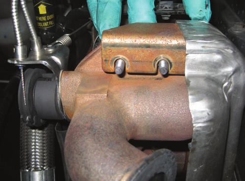 Remove the 8mm bolt at the front of the engine that holds the crossover pipe in place.