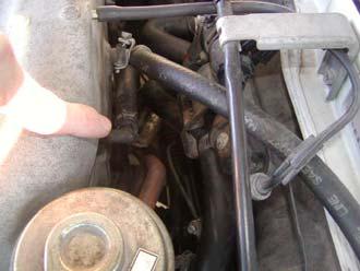 13) Now, go on the other side of the engine bay and remove the vacuum hose on the power valve actuator.