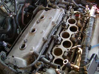 27) Remove the 3 coil packs. 28) Remove the 6 allen head bolts on the upper intake manifold.