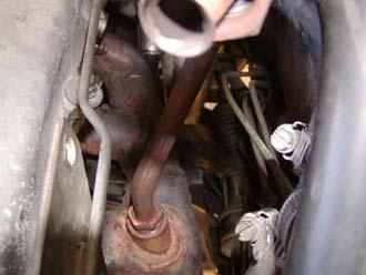 You can use a 22mm open ended wrench or an adjustable wrench. 32) Install the exhaust manifold block plug.
