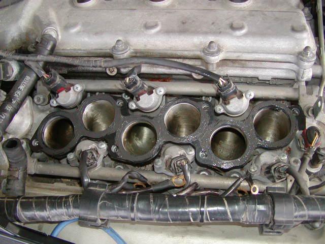 34) Carefully place the upper intake spacer on the lower intake manifold on the motor. Push it down firmly.