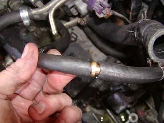 43) Install the vacuum cap to the fitting on the EGR solenoid as shown