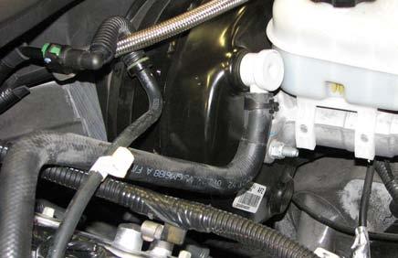 Disconnect the vacuum hose from the brake booster fitting; it will be removed with the