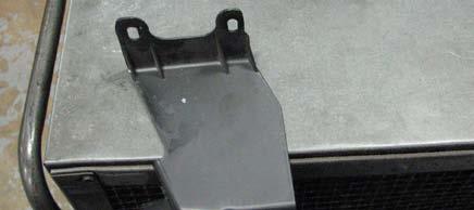 Use the supplied bit to drill a 15/64 hole in the passenger side of the upper radiator shroud according to the