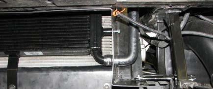 Install the short molded hose from the outlet of the intercooler water pump to the heat exchanger inlet.