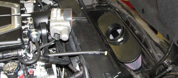 202. Connect the intercooler hose assembly to the two upper hose fittings at the