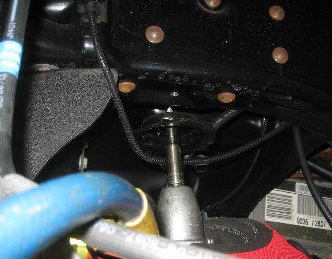 Using the OE bolt, connect the bumpstop relocation