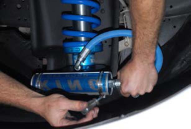 Move the coilover into position and tighten the top mounting bolts. (45) Accessing these bolts through the engine compartment may be necessary.