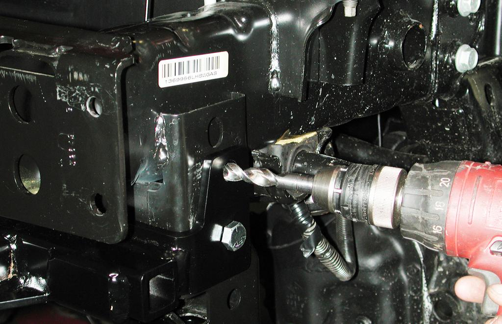 Using the pre-existing hole in the outside upper mounting point of the main receiver brace as a template, drill a ½" hole through the frame rail (Fig.K). 8.