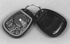 To replace the battery in the keyless entry transmitter, do the following: 1. Insert a thin object, such as a coin, in the slot between the covers of the transmitter housing near the key ring hole.